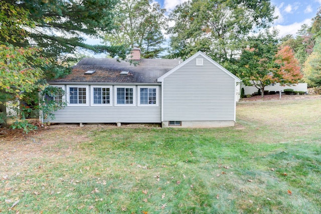 rear view of house with a lawn