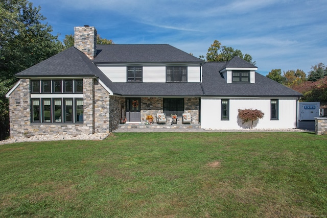 view of front facade with a front lawn and a patio area