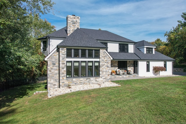 rear view of property with a lawn and a patio area