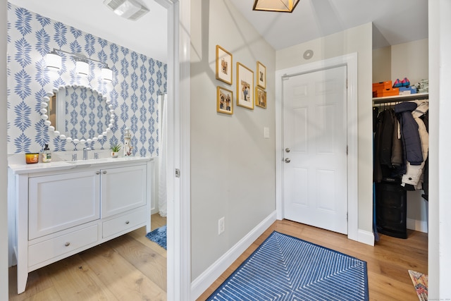 entrance foyer with light wood-type flooring and sink