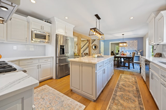 kitchen with white cabinetry, a center island, and stainless steel appliances