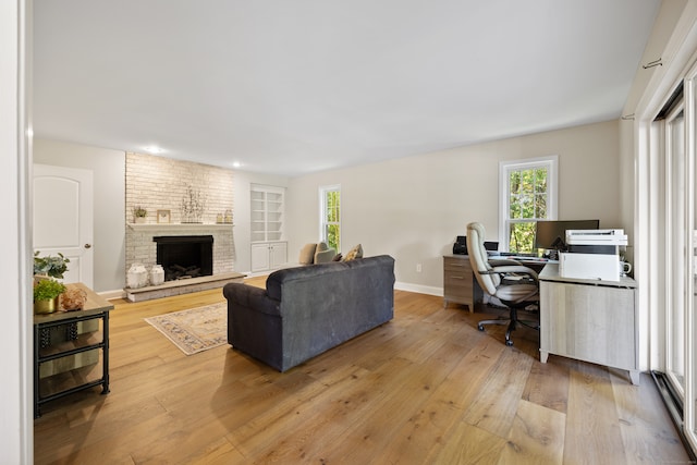 living room with a fireplace and light hardwood / wood-style floors