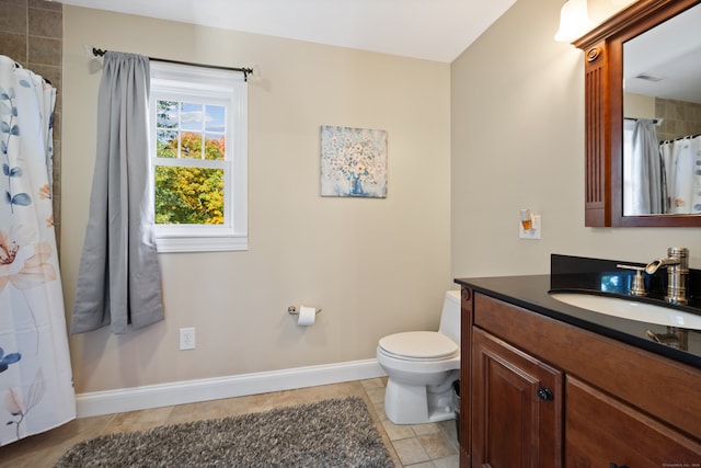 bathroom with vanity, tile patterned flooring, and toilet