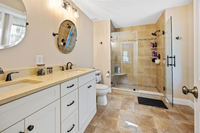 bathroom with walk in shower, vanity, and toilet