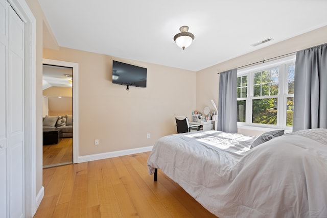 bedroom featuring a closet and light hardwood / wood-style floors