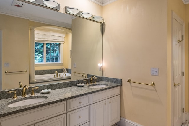 bathroom with vanity, a bathtub, ornamental molding, and ornate columns