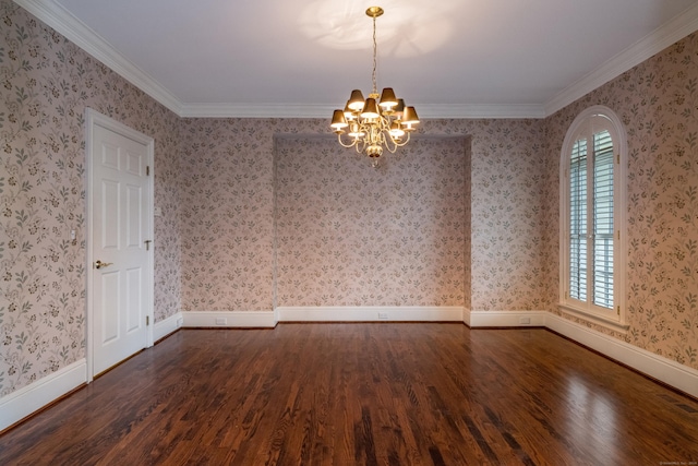 spare room with dark hardwood / wood-style flooring, ornamental molding, and a chandelier