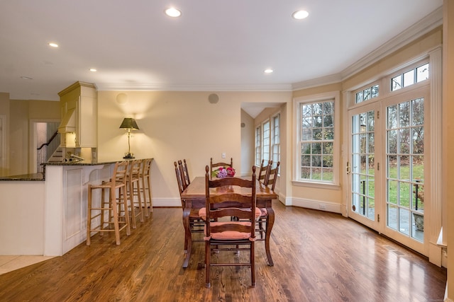 dining area featuring hardwood / wood-style floors, french doors, and ornamental molding