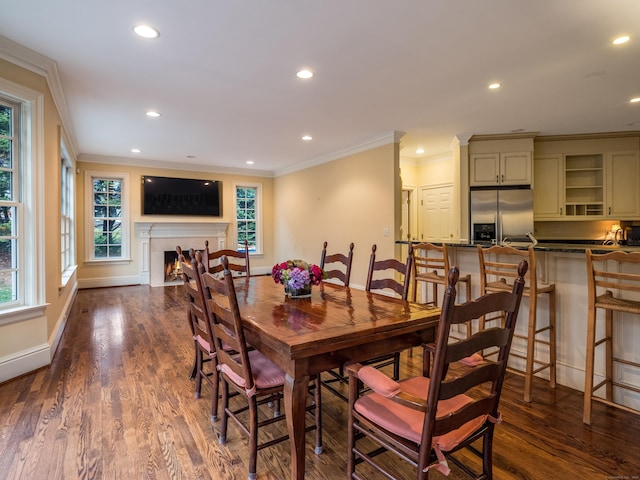 dining room featuring a wealth of natural light, dark hardwood / wood-style flooring, and ornamental molding