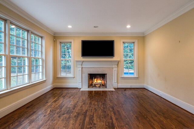 unfurnished living room with dark hardwood / wood-style flooring, crown molding, and plenty of natural light