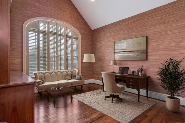 home office featuring dark wood-type flooring and high vaulted ceiling