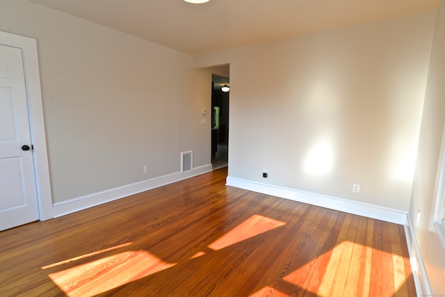 unfurnished room with hardwood / wood-style flooring