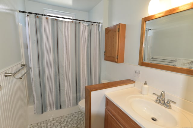 full bathroom featuring vanity, shower / tub combo, and toilet