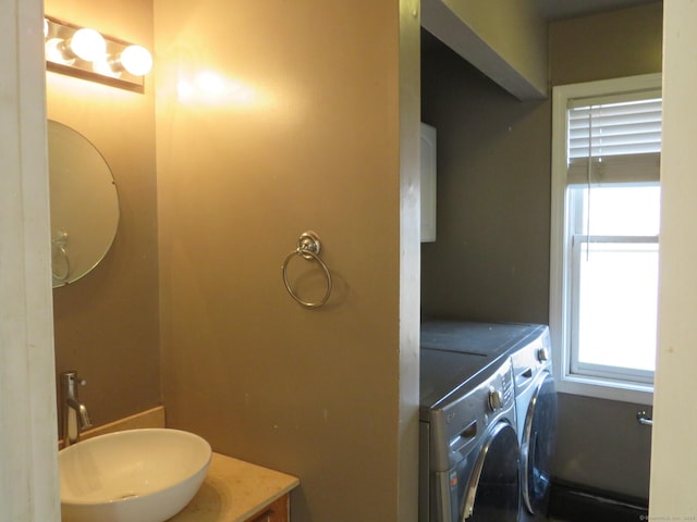 bathroom featuring vanity and washer and dryer