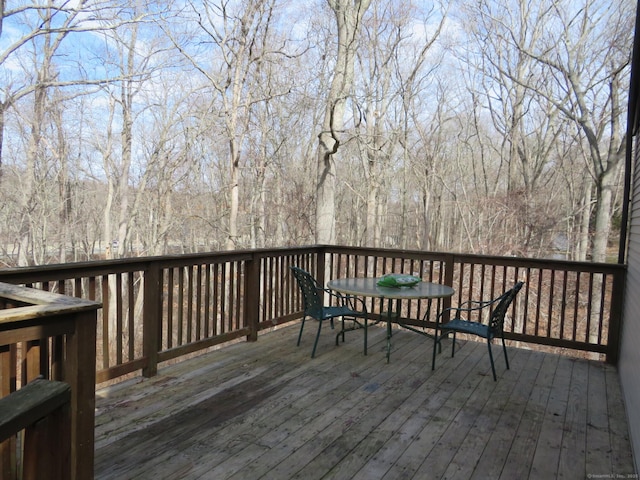 wooden terrace featuring outdoor dining space