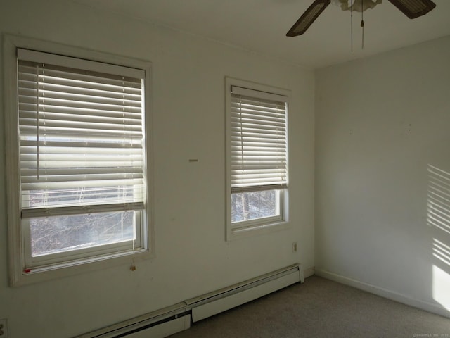 carpeted spare room featuring a baseboard heating unit, ceiling fan, and baseboards