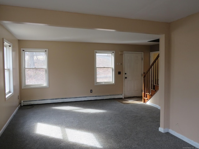 interior space with carpet floors, a baseboard radiator, baseboards, and stairs