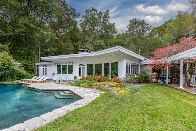 back of property featuring a yard and a patio area