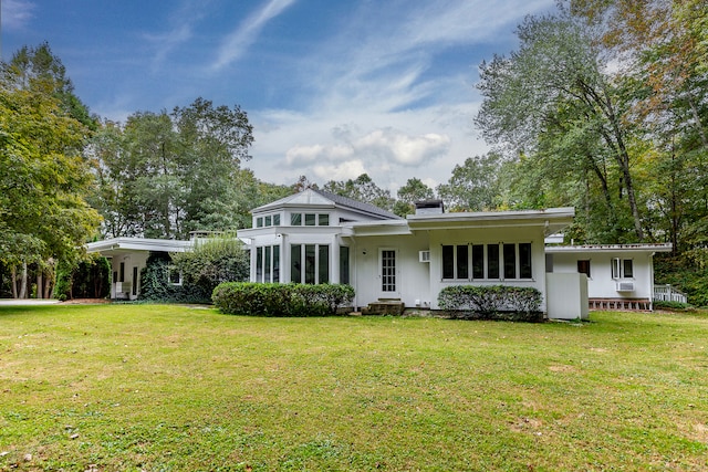 rear view of house featuring a yard