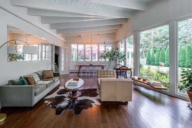 sunroom featuring lofted ceiling with beams and an inviting chandelier