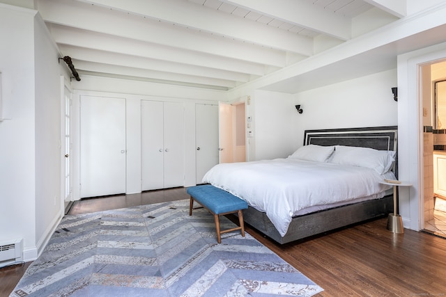 bedroom featuring dark wood-type flooring and beam ceiling