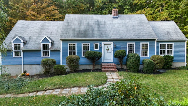 new england style home with a front lawn