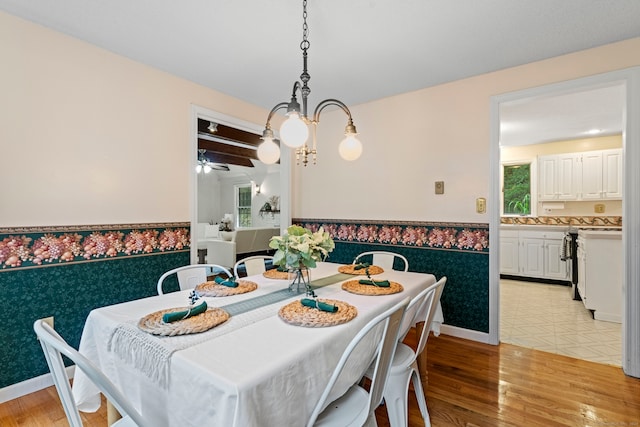 dining space featuring ceiling fan with notable chandelier, light hardwood / wood-style flooring, and plenty of natural light