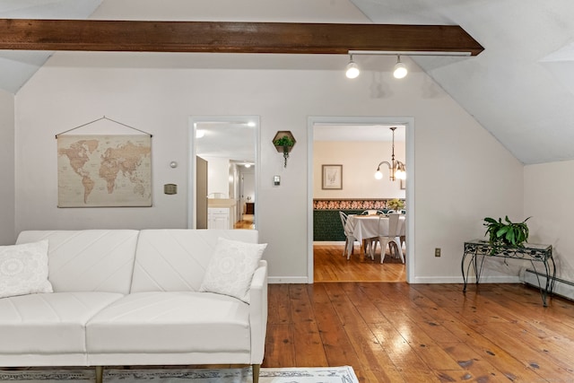 living room with vaulted ceiling with beams, hardwood / wood-style floors, and a notable chandelier