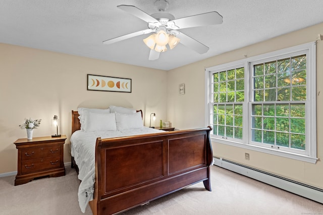 carpeted bedroom with a textured ceiling, ceiling fan, and a baseboard radiator