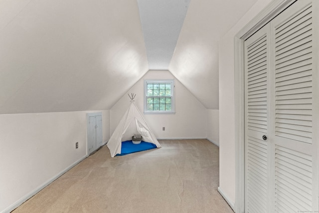 recreation room featuring light colored carpet and lofted ceiling