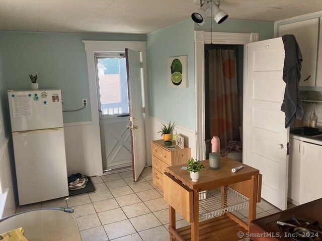 doorway with light tile patterned flooring