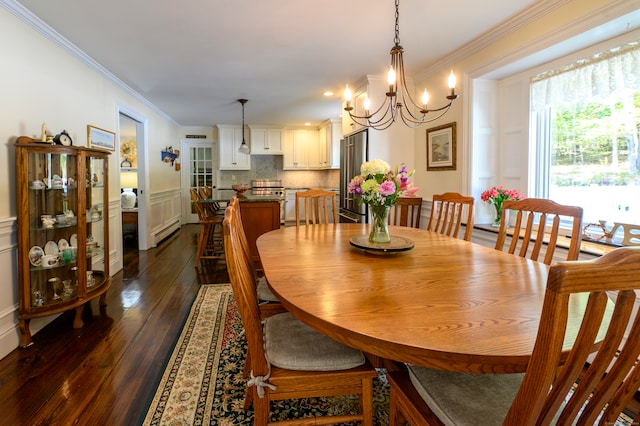 dining area featuring ornamental molding, a chandelier, a baseboard radiator, and dark wood-type flooring