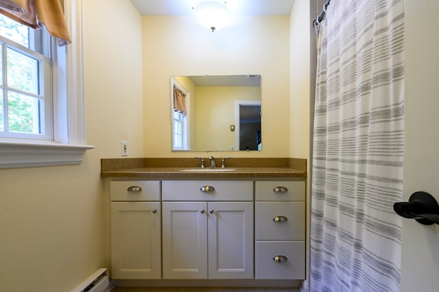 bathroom with vanity, a baseboard radiator, and a shower with shower curtain