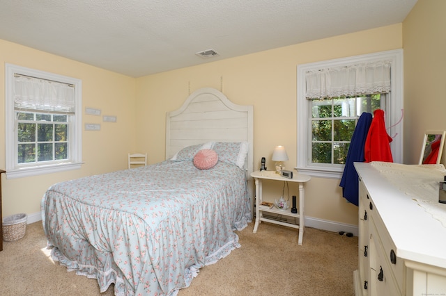 carpeted bedroom with a textured ceiling