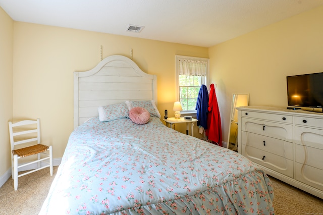 bedroom featuring light colored carpet