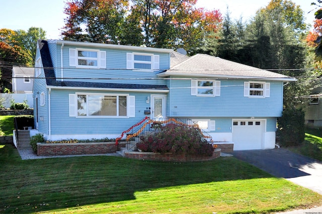 view of front of property with a garage and a front lawn