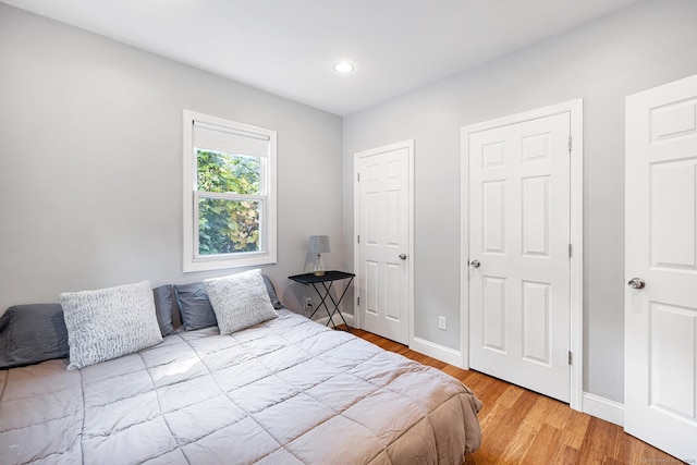 bedroom featuring wood finished floors and baseboards