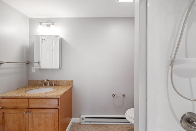 bathroom featuring toilet, baseboard heating, vanity, baseboards, and tile patterned floors