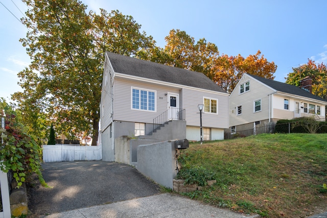 view of front of house featuring a front yard and a garage