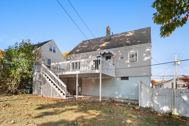 rear view of property with a wooden deck