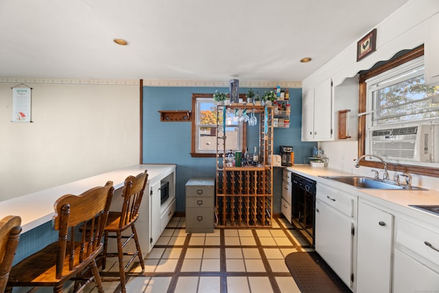 kitchen featuring white cabinets, light tile patterned floors, cooling unit, dishwasher, and sink