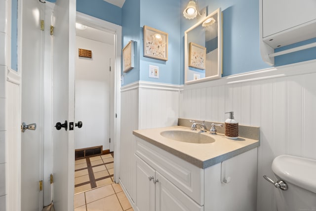 bathroom featuring vanity, toilet, and tile patterned floors