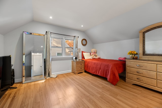 bedroom featuring vaulted ceiling and light hardwood / wood-style flooring