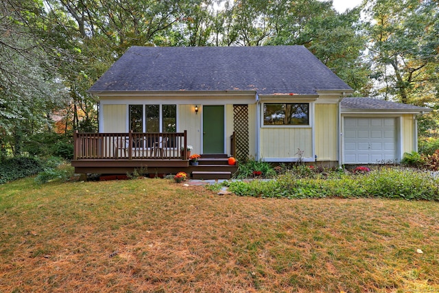 view of front of house featuring a garage, a deck, and a front lawn