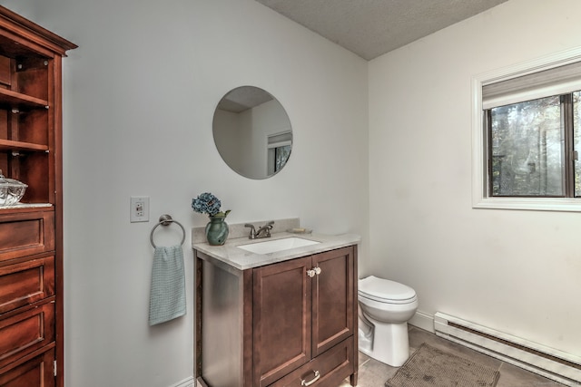 bathroom featuring tile patterned flooring, toilet, baseboard heating, vanity, and a textured ceiling