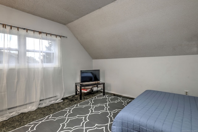 carpeted bedroom featuring lofted ceiling and a textured ceiling