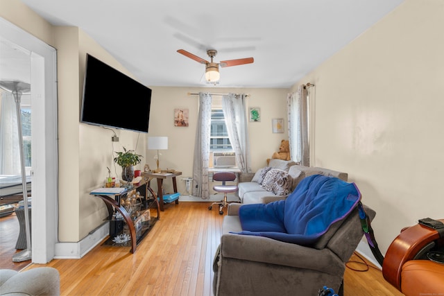 living room featuring ceiling fan and light wood-type flooring