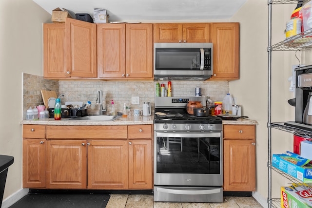 kitchen with stainless steel appliances, backsplash, and sink