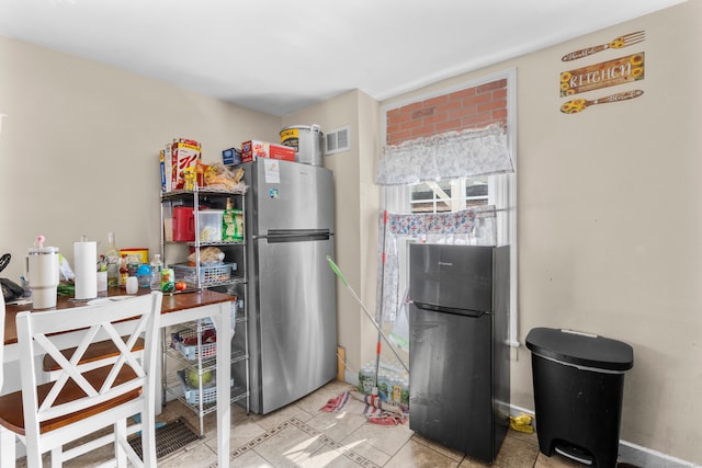 kitchen with fridge and stainless steel refrigerator