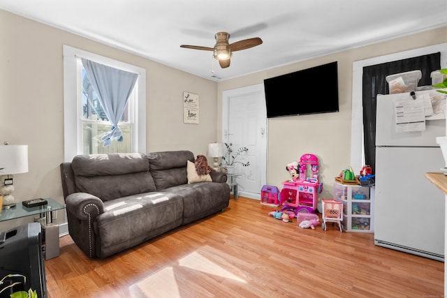 living room featuring ceiling fan and hardwood / wood-style floors